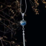 Silver glass pendant with  droplets and chain tassel on long chain.
