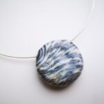 Ivory and black holow blown glass bead on sterling silver wire
