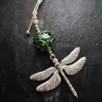 Brooch with Dragonfly pendant and transparent green bead with DX - Image 3